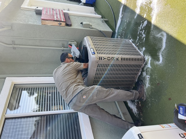Cozy Conditions technician servicing a York outdoor unit